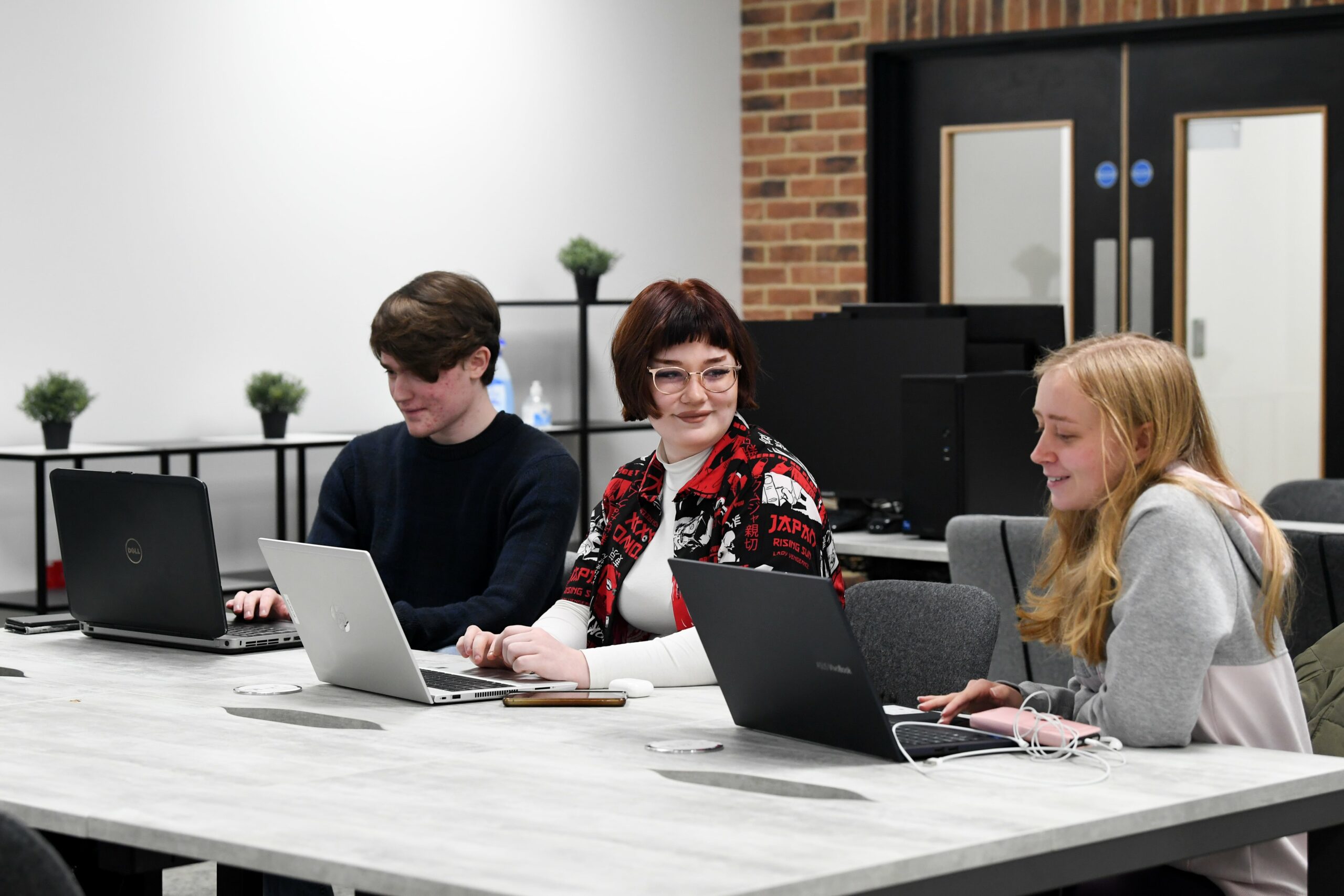 SCIoT Classroom with 3 students sat at a desk using their laptops