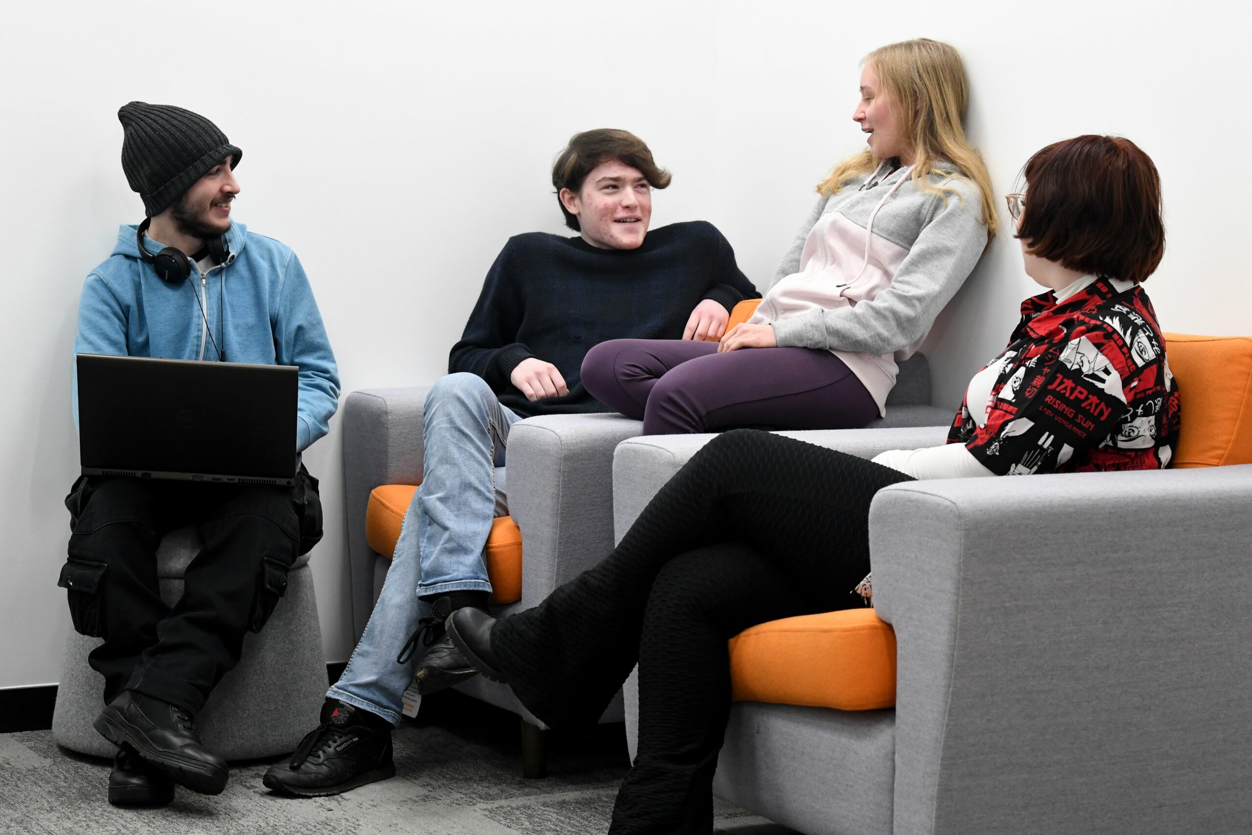 Group of students sat in a communal space talking