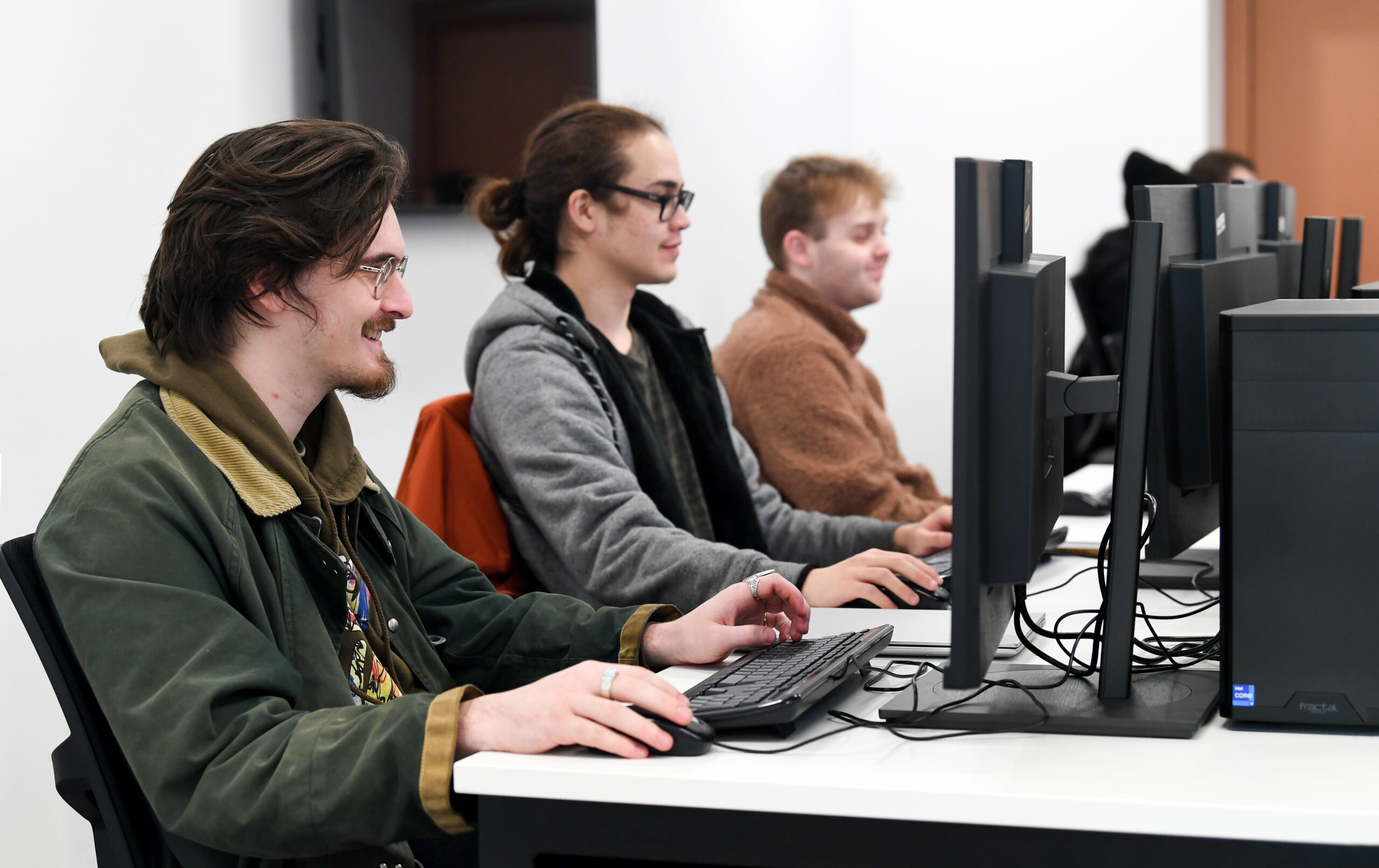 SCIoT computer classroom with 3 students sat at computers working