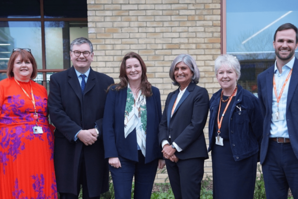 Gillian Keegan MP and Iain Stewart MP (third and second from left respectively) pictured with senior leaders from the SCIoT in Bletchley. They are stood outside the SCIoT building in Bletchley.